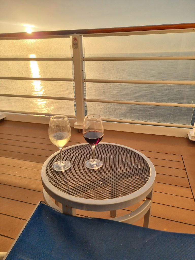 Glasses of wine on the verandah at sunset
