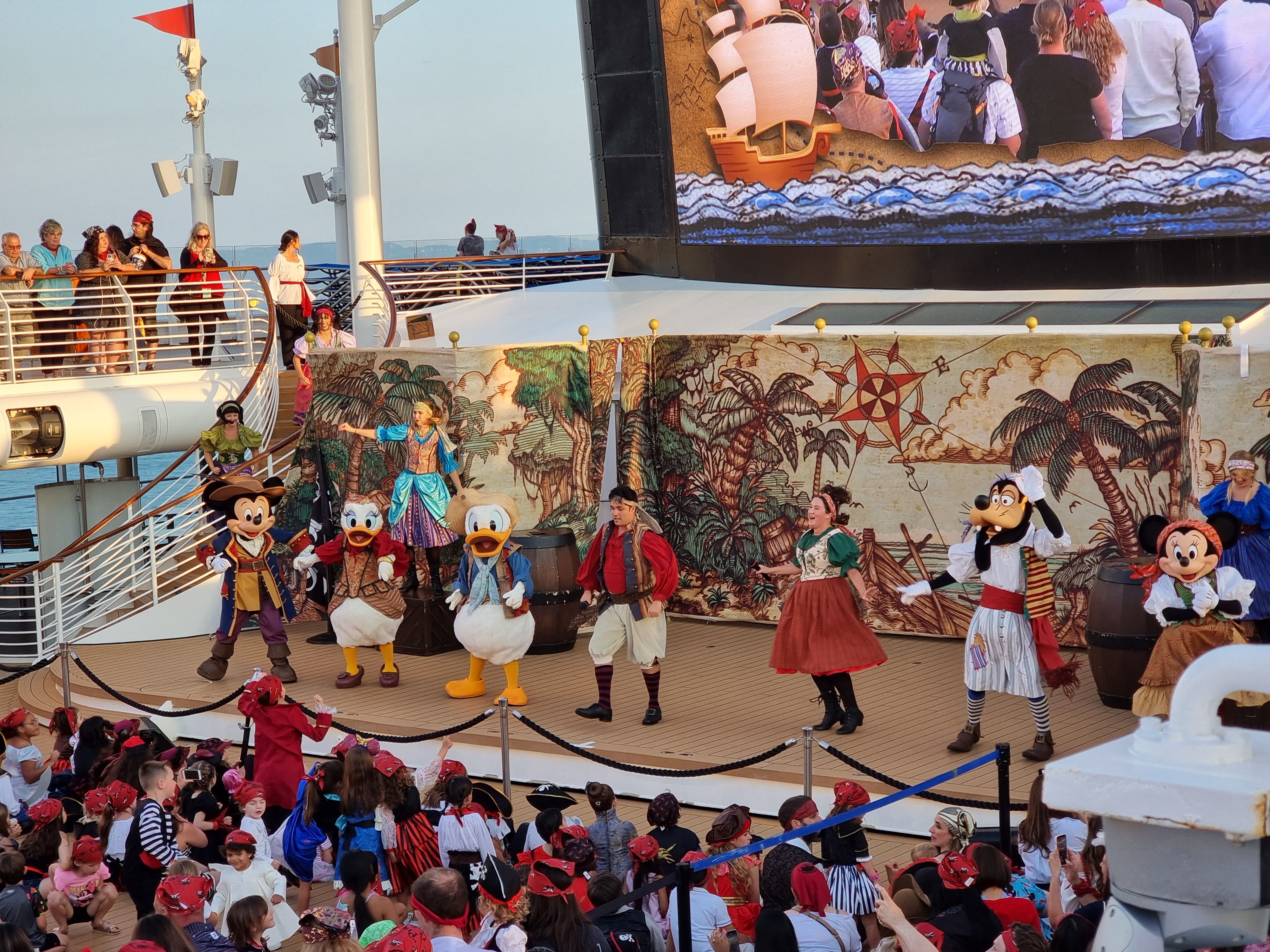 Mickey, Daisy, Donald, Goofy and Minnie with the entertainment team during the Pirate deck show