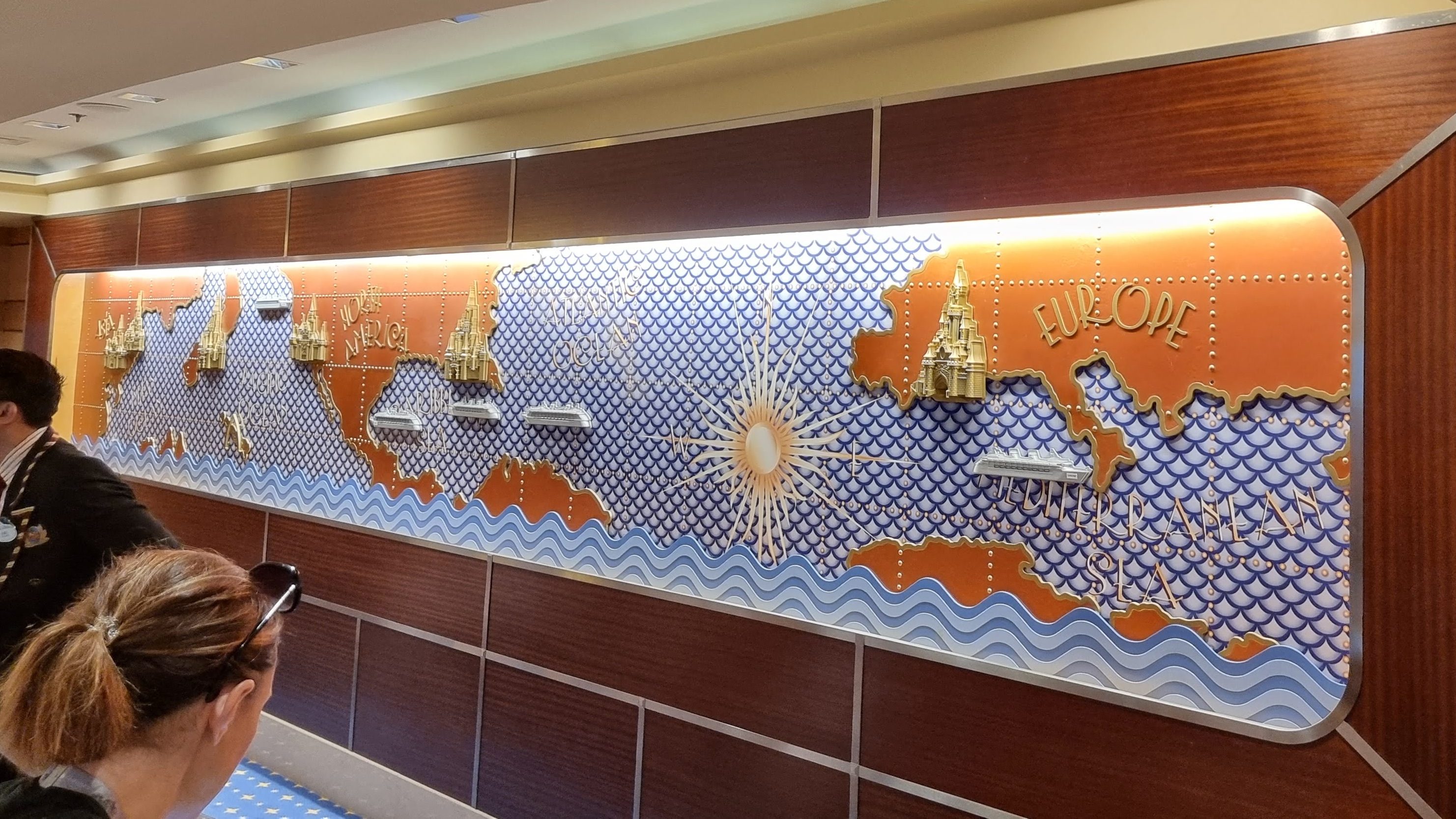 Map behind Guest Services showing Disney parks and cruise ships