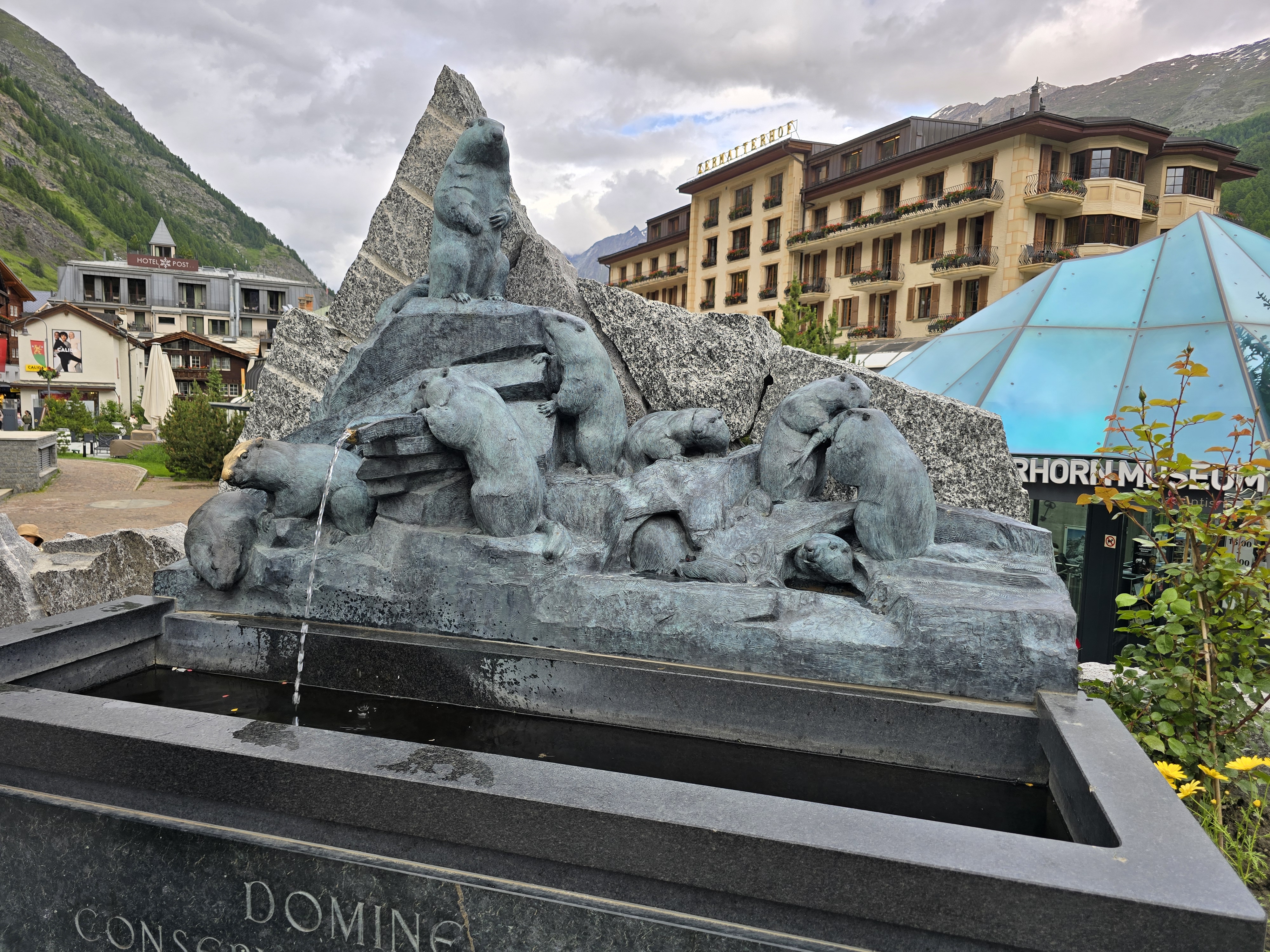 The fountain in Zermatt, in front of the Matterhorn Museum and the Grand Hotel.
