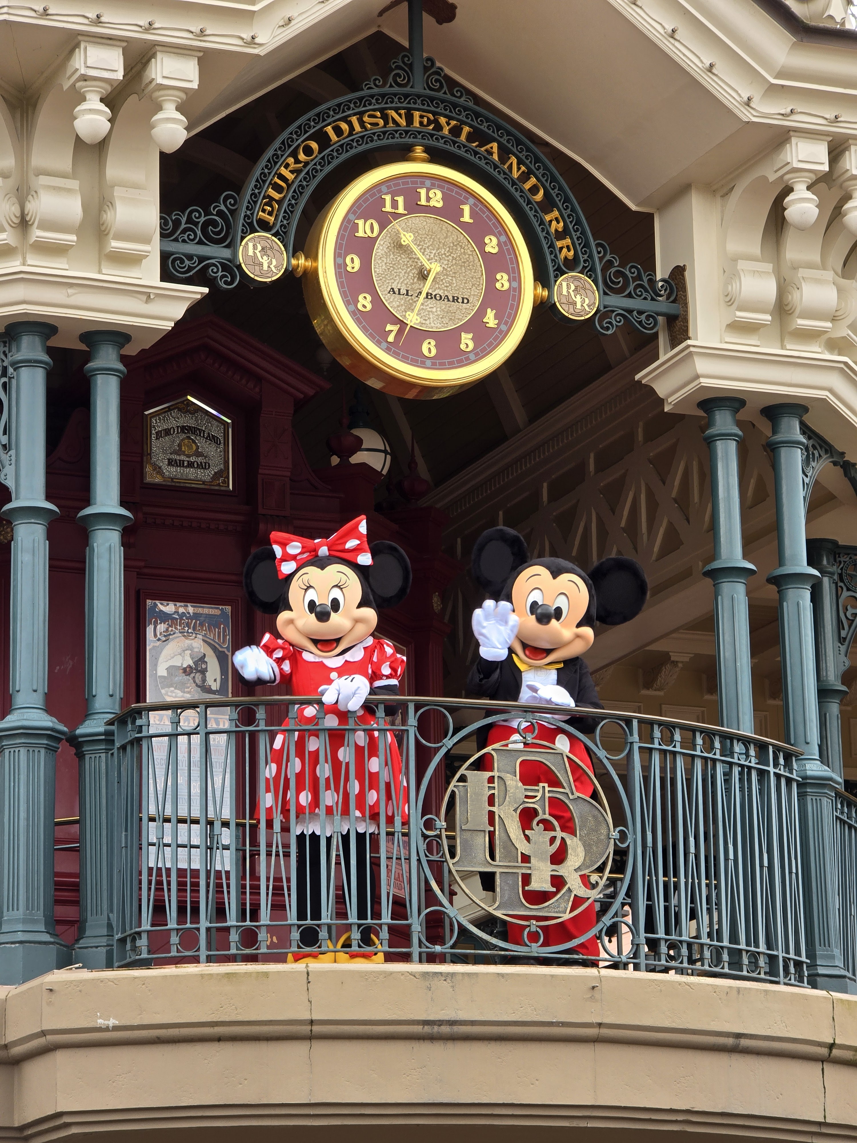 Minnie and Mickey greeting guests from the train station